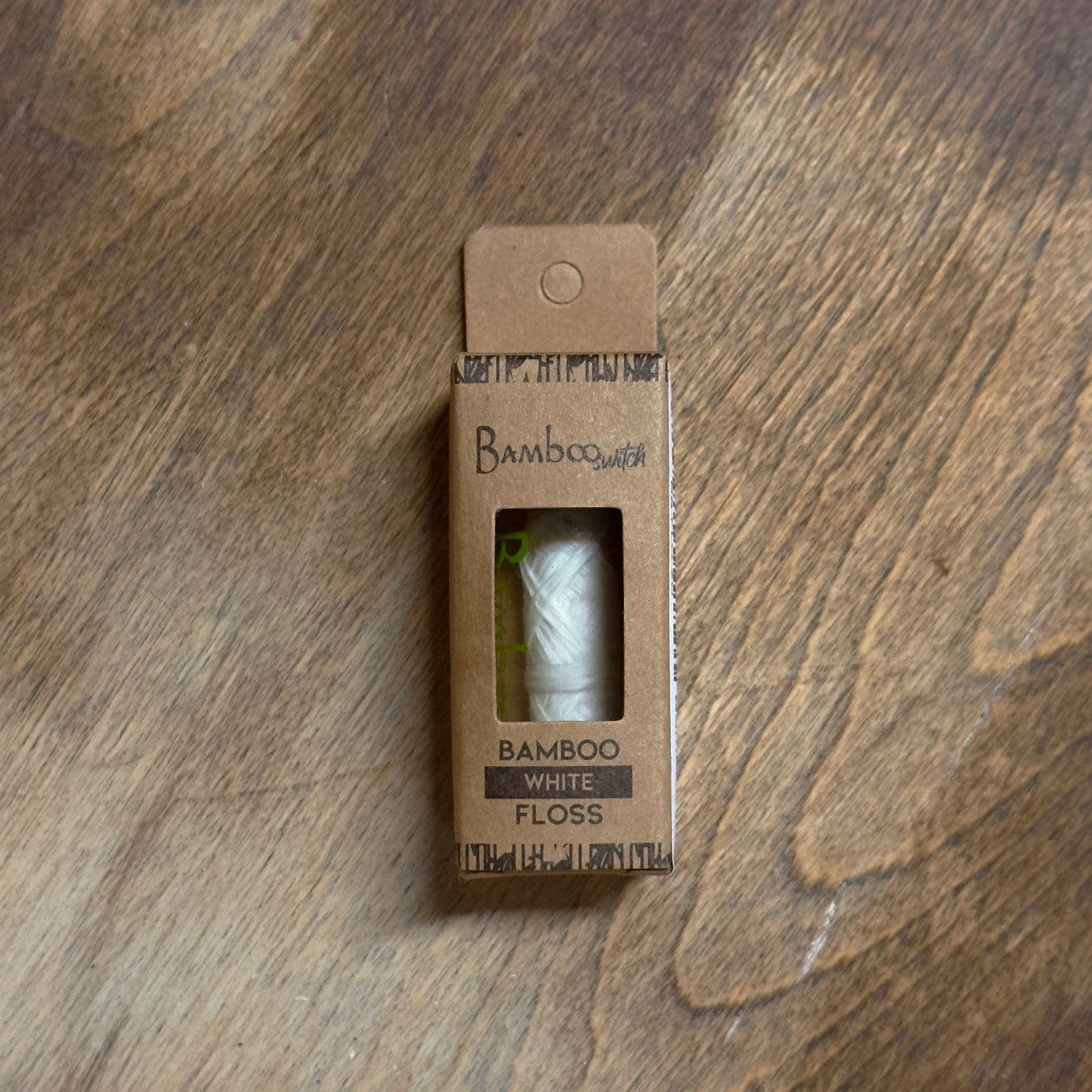 Box of Bamboo White Floss on a wooden surface