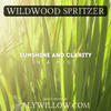 Sunlight filtering through lush green grass, evoking the refreshing scent of Wildwood Spritzer mist.