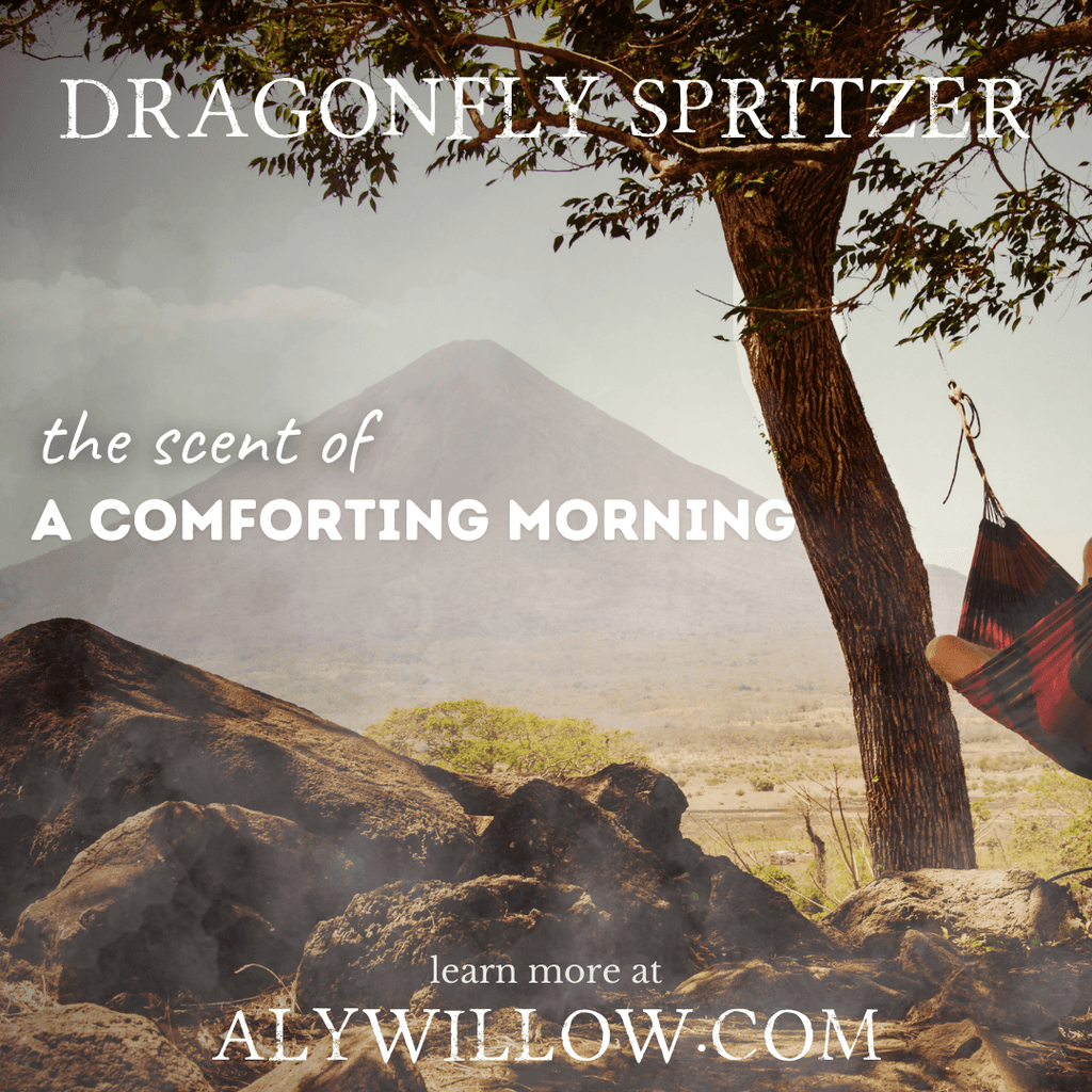 A serene setting with a hammock by a tree, overlooking a mountain landscape, evocative of the comforting scent of Dragonfly Spritzer.