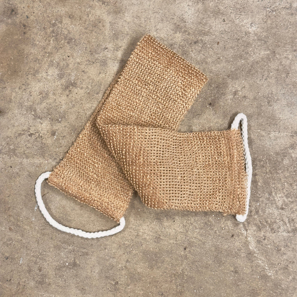 Back Strap scrub with white strings on a concrete surface