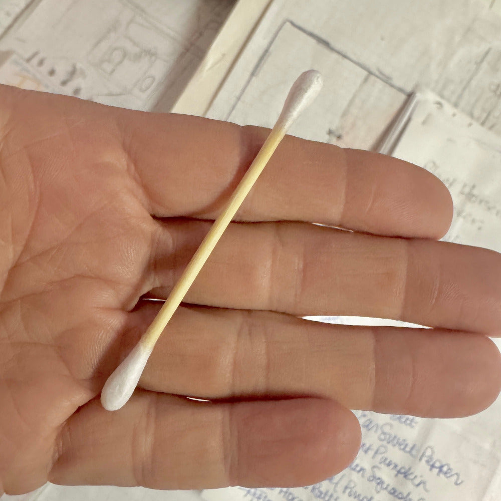 Single bamboo cotton bud in palm of hand