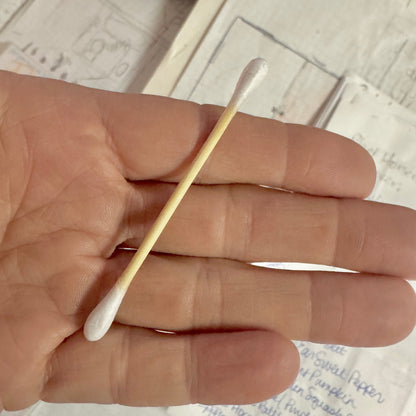 Single bamboo cotton bud in palm of hand