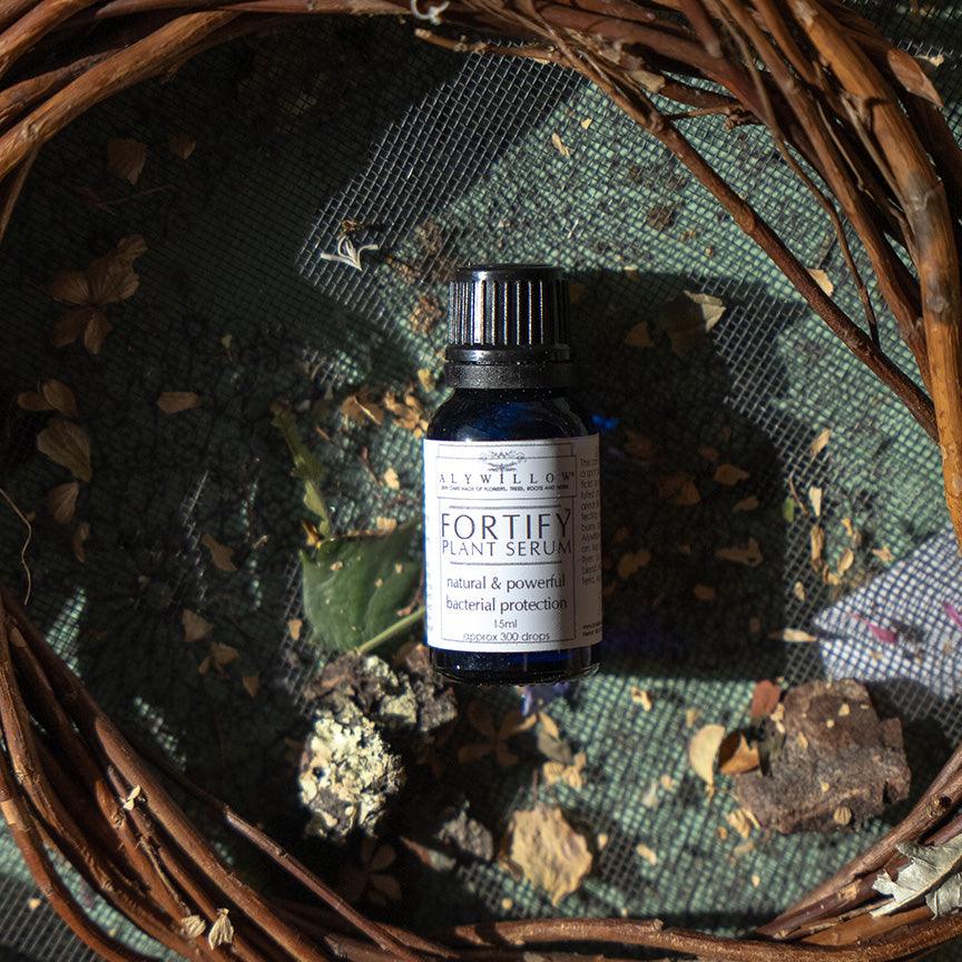 bottle of Fortify on a table with nature things