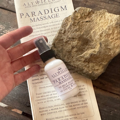 Hand holding Paradigm Bottle and flyer on table