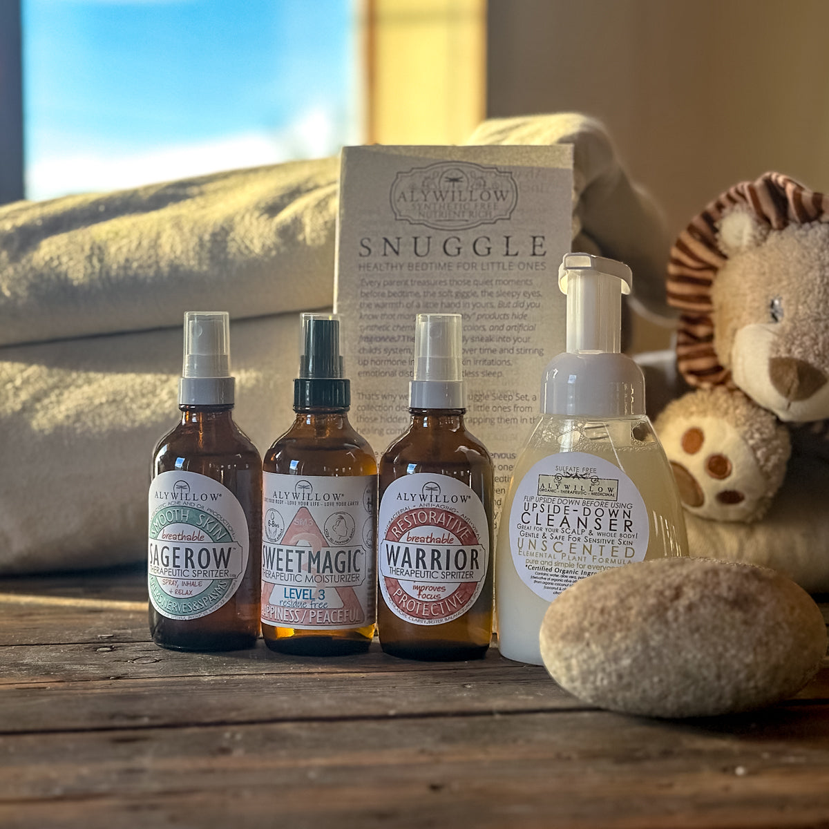 Set of bottles with labels and a box on a wooden surface with a soft focus background