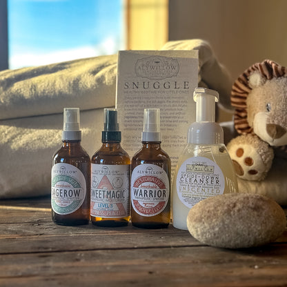Set of bottles with labels and a box on a wooden surface with a soft focus background