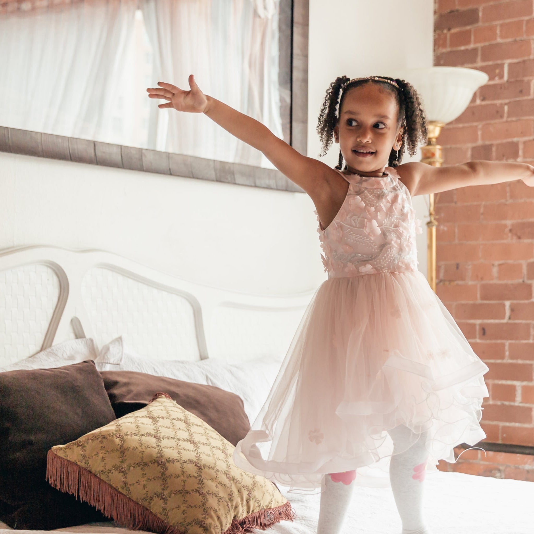 child in costume on bed