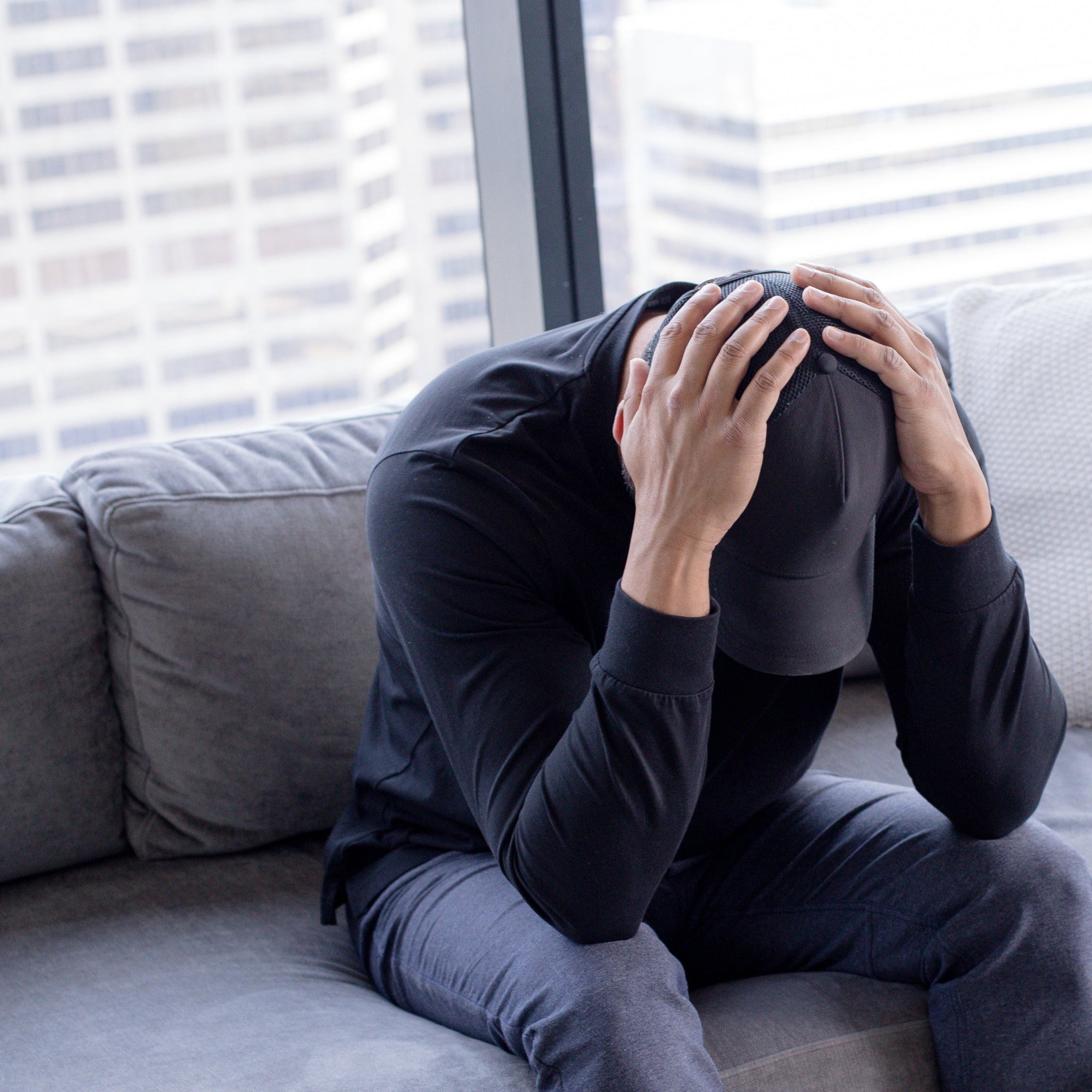 man with hands on head